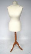 A modern dressmakers mannequin, raised upon tripod supports,
