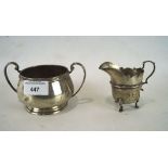A late Victorian twin handled silver sugar bowl together with a silver cream jug,