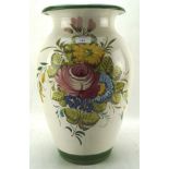 A large terracotta vase decorated with flowers on a cream ground,