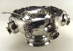 A large silver plated punch bowl, with six matching cups and a ladle,