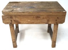 A pine workbench on squared supports,
