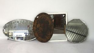 Three vintage wall mirrors and a painted wall plaque, one framed in wood, two with bevelled edge,