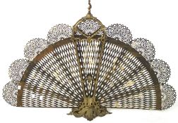 An ornate brass peacock fan fire screen,