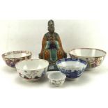 Five Qing dynasty and Chinese export dishes and a stoneware glazed figure of a seated official,