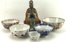 Five Qing dynasty and Chinese export dishes and a stoneware glazed figure of a seated official,