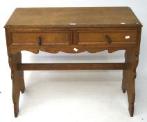 An early 20th Century oak hall table, with two short drawers to the front,