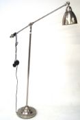 A contemporary metal floor lamp with adjustable reading light,