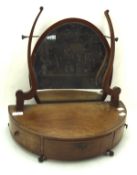 A 19th century oval swing mirror on a half moon three-drawer base, on metal ball and claw feet,