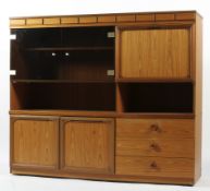 A 20th century veneered and glazed display and storage cabinet, with glass doors and three drawers,