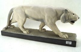 A large resin sculpture of a striding snow leopard,