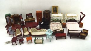 A collection of dolls house furniture and decorative items including beds, tables, dressers,