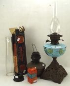 A Victorian oil lamp with blue opaline glass reservoir, on a pierced cast iron base,
