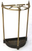 An early 20th century brass half moon umbrella stand,