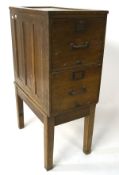 An early 20th century wooden filing cabinet on stand, comprrising two drawers,