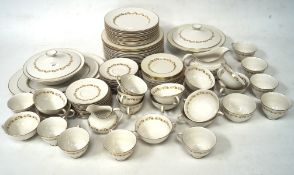 A Royal Doulton 'Fairfax' dinner service with bands of gilt leaves on a white ground