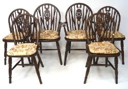 A set of six wheelback chairs including two armchairs,