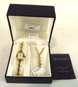 A modern ladies Sekonda wristwatch and necklace set, gilt metal set with white stones in places,