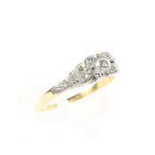 An unmarked yellow and white metal diamond set ring,