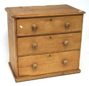 A Victorian pine chest of drawers, comprising three long drawers, of graduating form,