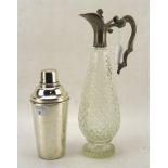 A slender pear-shaped cut glass wine jug and a sliver plated cocktail shaker,