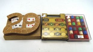 A collection of contemporary casino counters and a cribbage board,