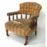 An Edwardian buttonback tub chair with half turned spindle back,