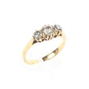 A gold (unmarked) three stone diamond ring