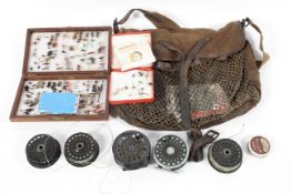 A game keeper's bag with an assortment of fishing flies and fly reels