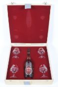 A bottle of Camus Grand VSOP Cognac with four brandy glasses