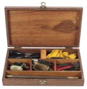 A vintage gun cleaning kit, housed in a wooden case,