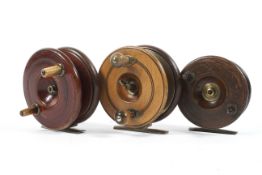 A group of three early 20th century wooden star back fishing reels,