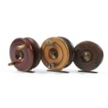 A group of three early 20th century wooden star back fishing reels,