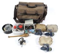 A large Wychwood fishing bag containing a selection of fishing gear, to include assorted reels,