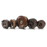 A selection of five early 20th century wooden brass mounted fishing reels,