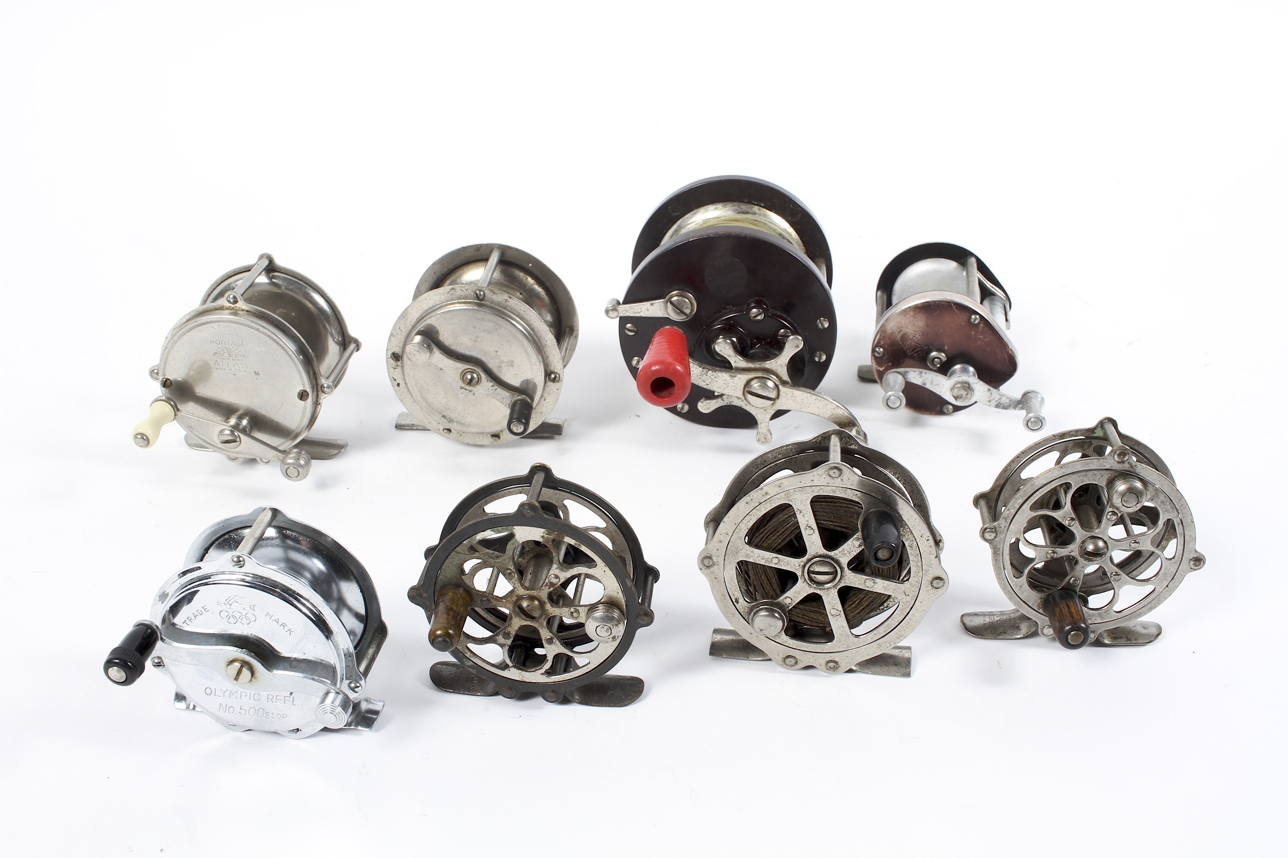 A collection of assorted fishing reels,