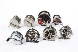 A collection of assorted fishing reels,