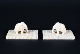 A 19th century Indian pair of ivory elephants with pendant trunk,