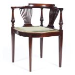 An Edwardian mahogany corner elbow chair,