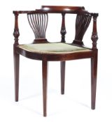 An Edwardian mahogany corner elbow chair,