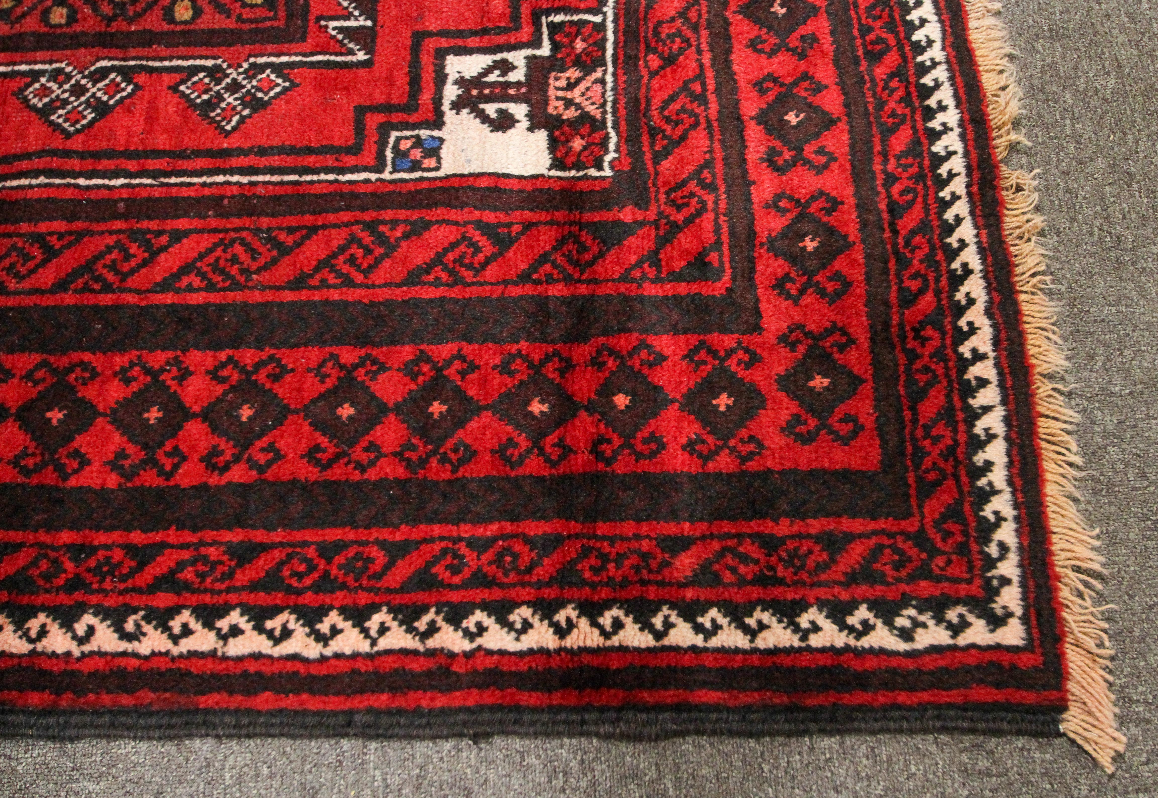 An eastern wool work Gonbad medallion red rug. - Image 2 of 3