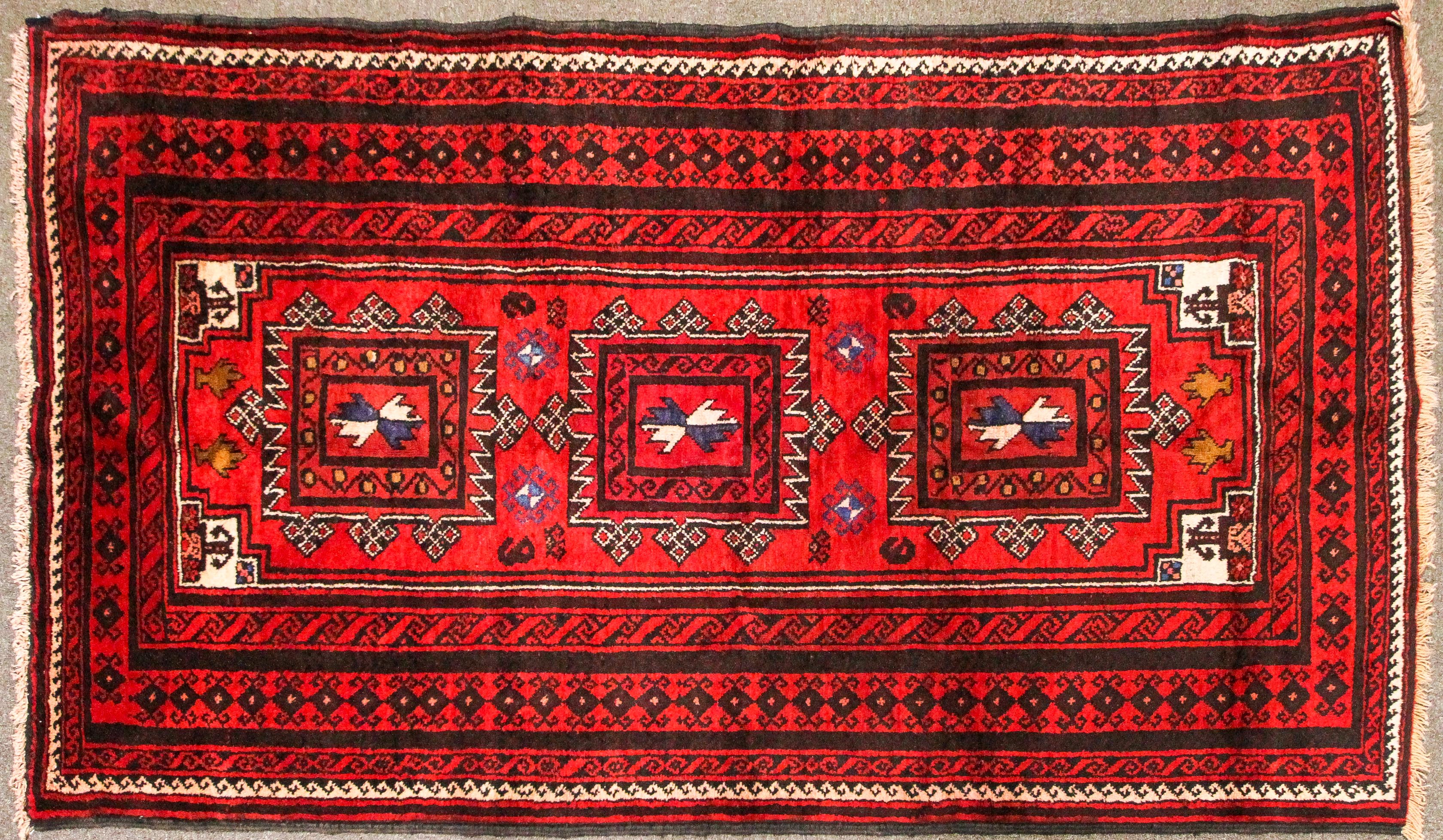 An eastern wool work Gonbad medallion red rug.