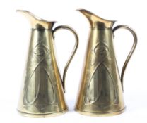 A pair of Art Nouveau brass embosed jugs, stamped J.