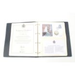 A folder containing The Royal Decades Coin Cover Collection