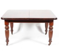 A Victorian mahogany wind out dining table with two extra leaves.