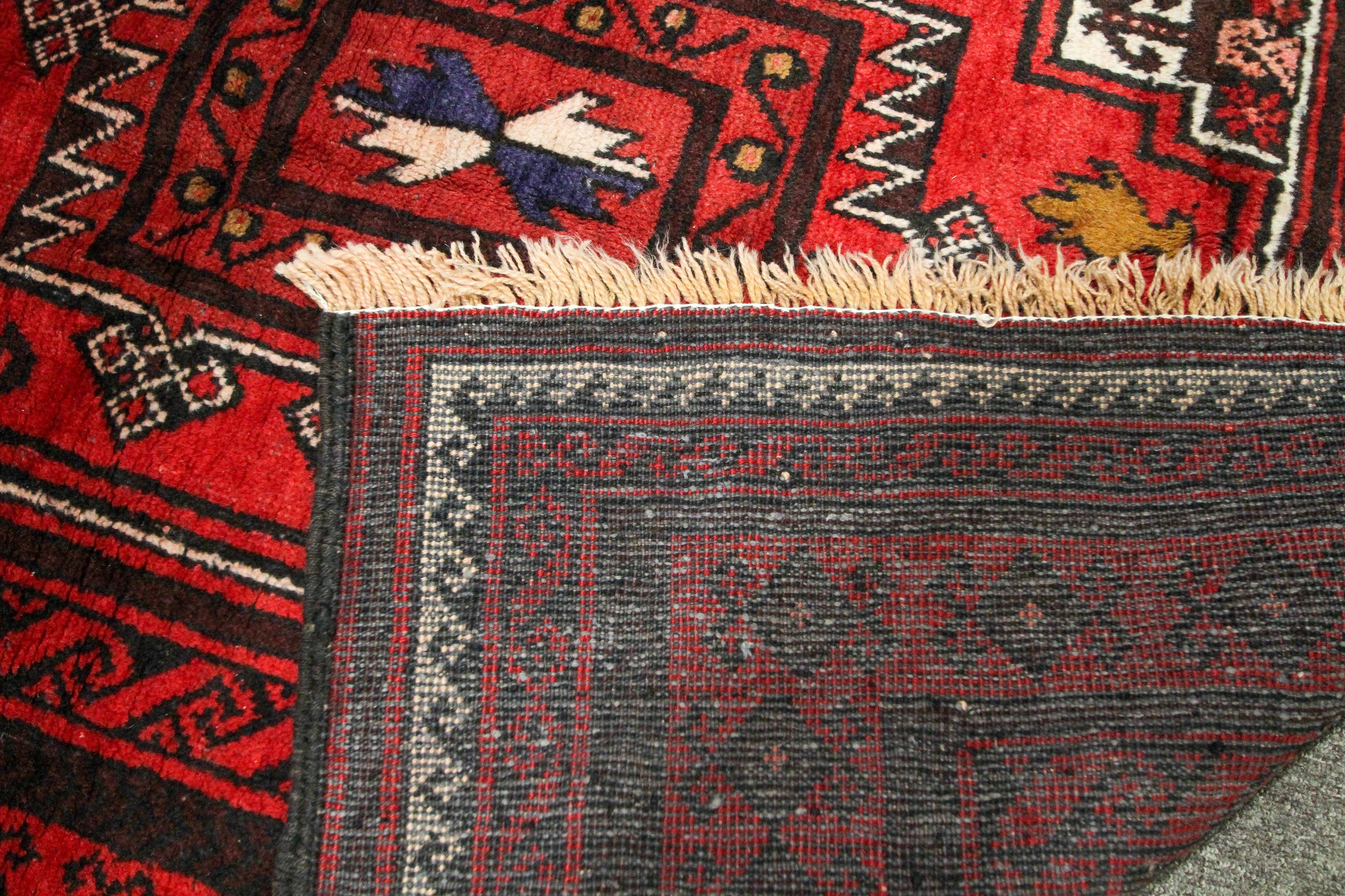 An eastern wool work Gonbad medallion red rug. - Image 3 of 3