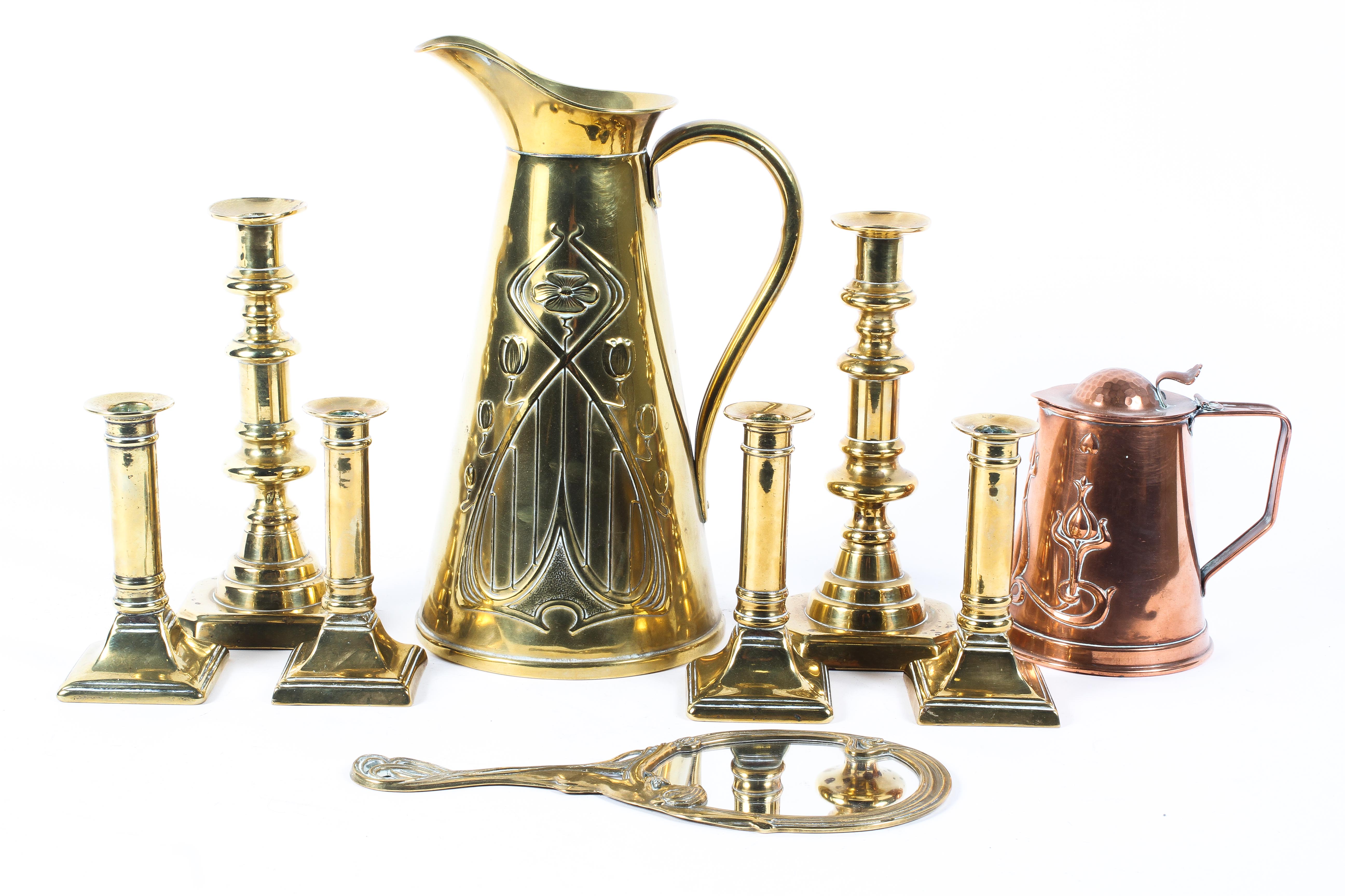 An assortment of brassware including Georgian candlesticks a JS&SB Art Nouveau copper jug,