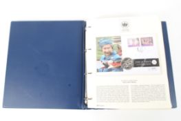 A folder containing The Queen's Golden Jubilee Coin Cover Collection