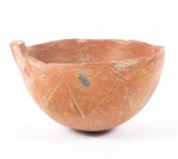 An early bronze age polished red earthenware bowl, incised with zig-zag ornament,