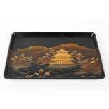 A large Japanese dark brown lacquer tray decorated in gold makie with a pavillion in a river