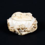 A Meiji Period (1868-1921) ivory oval box and cover carved with ten rats dancing and cavorting with